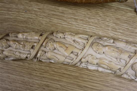 A Belgian Congo ivory oliphant, c.1900, carved with a procession of figures, hammerhead shark fishermen and 41cm